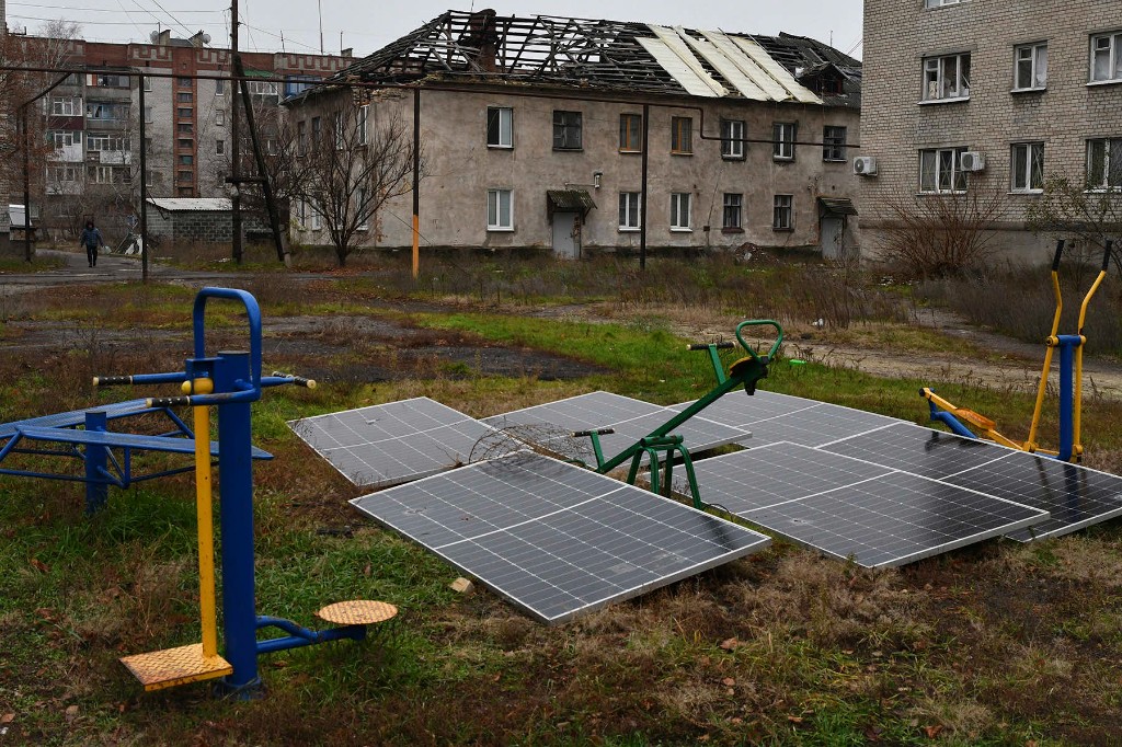 Destroyed civilian housing and damaged solar panels.